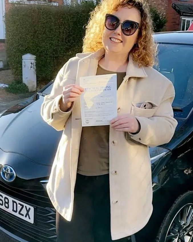 A Learn Local learner holding their driving test pass certificate (photo 6 of 8)