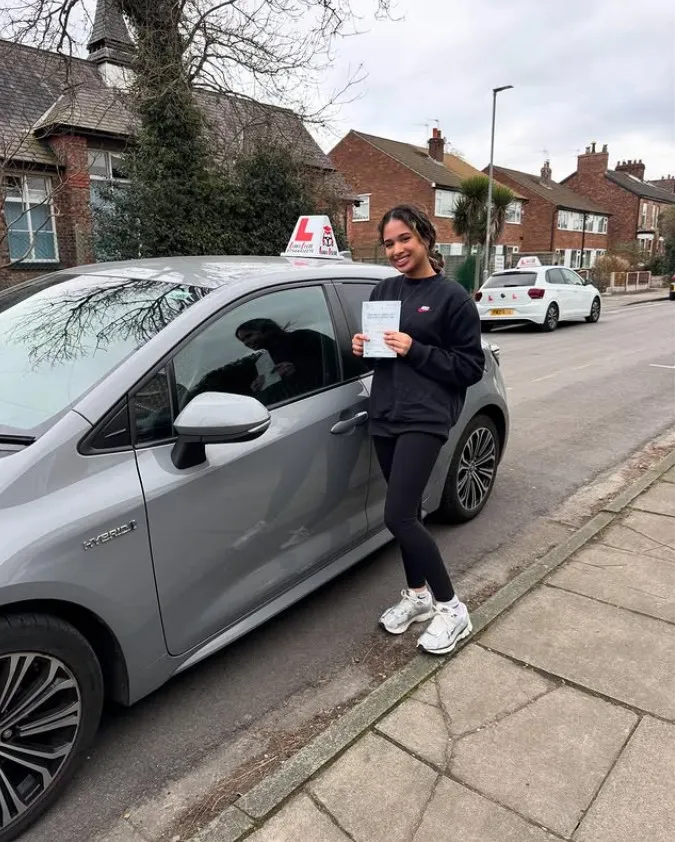 A Learn Local learner holding their driving test pass certificate (photo 2 of 8)